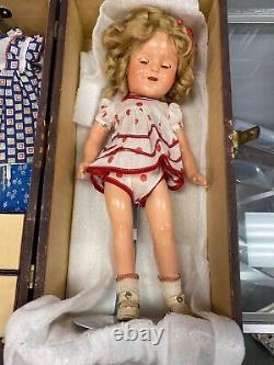 1930's Shirley Temple Doll with wooden case, clothes, ribbons, shoes and handker